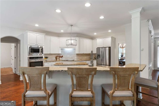 1055 Beacon Hill Xing, Alpharetta, GA 30005 - kitchen with appliances with stainless steel finishes, recessed lighting, backsplash, light stone countertops, and white cabinets