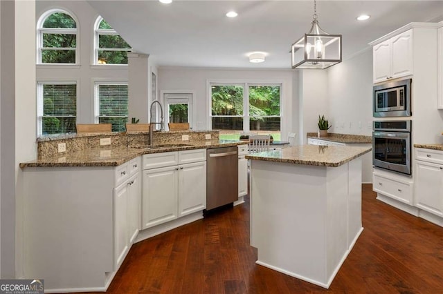 1055 Beacon Hill Xing, Alpharetta, GA 30005 - kitchen with stainless steel appliances, a center island, white cabinetry, dark wood-style floors, and recessed lighting