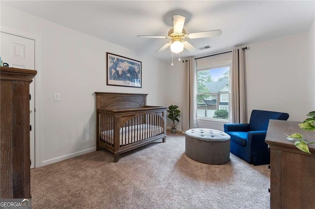 1055 Beacon Hill Xing, Alpharetta, GA 30005 - carpeted bedroom with a crib, baseboards, and a ceiling fan