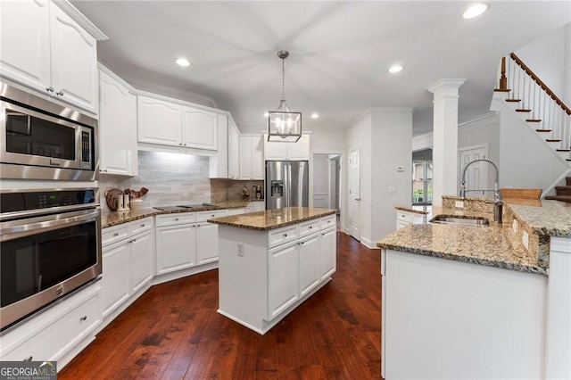 1055 Beacon Hill Xing, Alpharetta, GA 30005 - kitchen featuring appliances with stainless steel finishes, a sink, a kitchen island with sink, recessed lighting, and tasteful backsplash