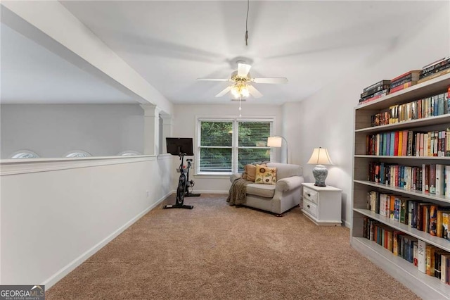 1055 Beacon Hill Xing, Alpharetta, GA 30005 - sitting room with carpet floors, ceiling fan, baseboards, and decorative columns