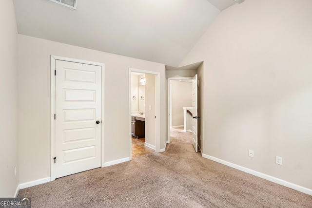 7946 White Oak Loop, Stonecrest, GA 30038 - unfurnished bedroom featuring vaulted ceiling and light colored carpet
