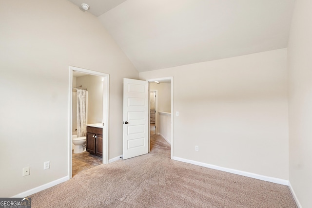7946 White Oak Loop, Stonecrest, GA 30038 - unfurnished bedroom featuring light colored carpet, vaulted ceiling, and ensuite bathroom