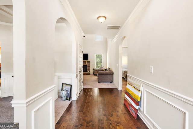 7946 White Oak Loop, Stonecrest, GA 30038 - hallway with crown molding, arched walkways, wainscoting, and dark wood-type flooring