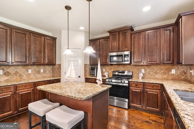 7946 White Oak Loop, Stonecrest, GA 30038 - kitchen featuring appliances with stainless steel finishes, light stone counters, dark wood-type flooring, dark brown cabinets, and recessed lighting