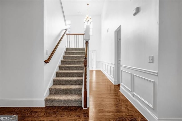 7601 Watson Cir, Locust Grove, GA 30248 - stairway with wood finished floors and a chandelier