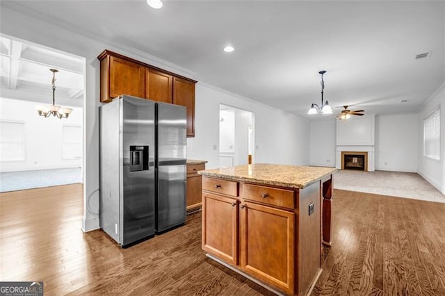 7601 Watson Cir, Locust Grove, GA 30248 - kitchen with a chandelier, stainless steel refrigerator with ice dispenser, a glass covered fireplace, dark wood finished floors, and recessed lighting