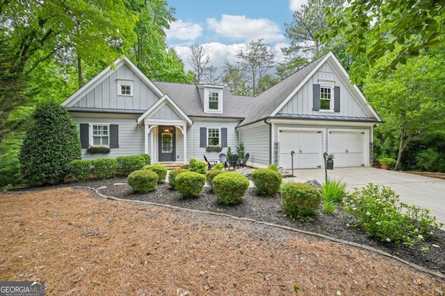81 Cane Mill Ln, Dahlonega, GA 30533 - view of front facade with board and batten siding, concrete driveway, a shingled roof, and a garage