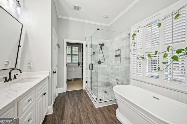 81 Cane Mill Ln, Dahlonega, GA 30533 - full bathroom featuring vanity, a soaking tub, a shower stall, crown molding, and wood finished floors