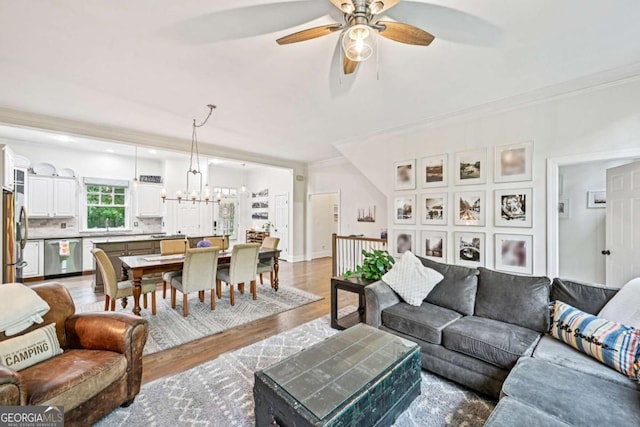81 Cane Mill Ln, Dahlonega, GA 30533 - living area featuring ceiling fan, light wood-style flooring, a chandelier, and ornamental molding