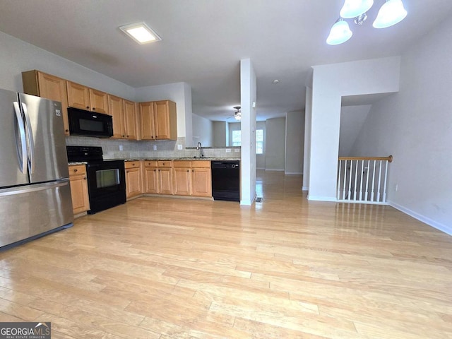 2104 Meadow Peak Rd, Duluth, GA 30097 - kitchen with black appliances, light wood-style floors, backsplash, a chandelier, and a ceiling fan