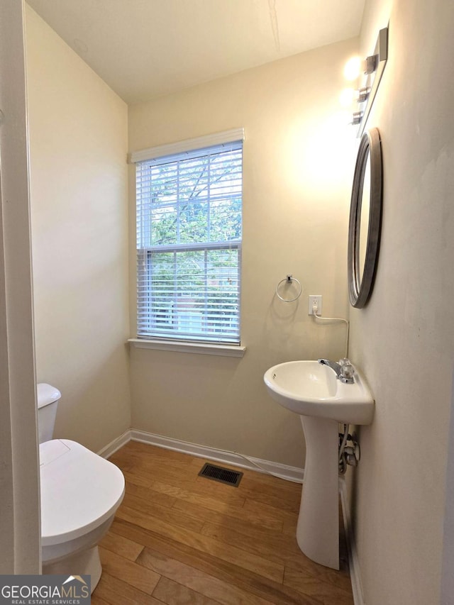 2104 Meadow Peak Rd, Duluth, GA 30097 - bathroom featuring baseboards and wood finished floors