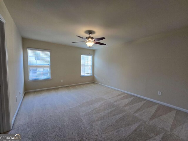 2104 Meadow Peak Rd, Duluth, GA 30097 - carpeted spare room with baseboards and ceiling fan