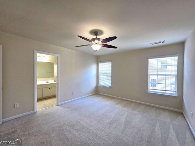 2104 Meadow Peak Rd, Duluth, GA 30097 - unfurnished bedroom with light carpet, ensuite bathroom, and a ceiling fan