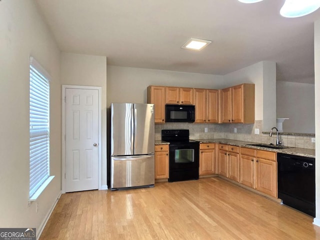 2104 Meadow Peak Rd, Duluth, GA 30097 - kitchen with black appliances, light wood finished floors, tasteful backsplash, and light brown cabinetry