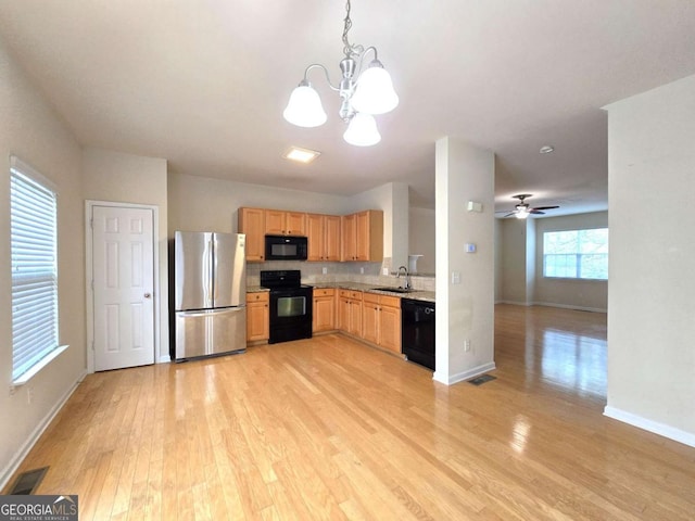 2104 Meadow Peak Rd, Duluth, GA 30097 - kitchen featuring black appliances, a chandelier, light wood finished floors, light brown cabinetry, and decorative light fixtures
