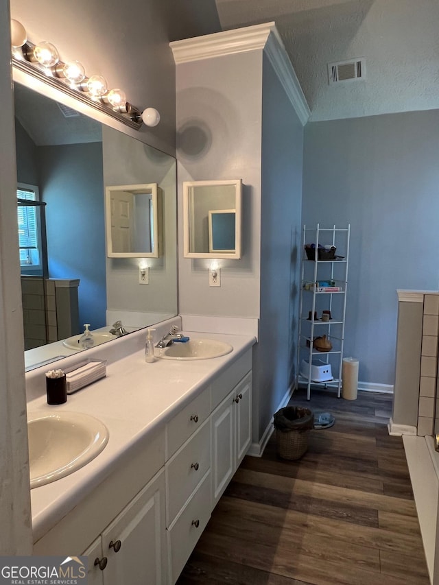 740 Pebble Blvd, Covington, GA 30016 - full bathroom with wood finished floors, double vanity, and baseboards