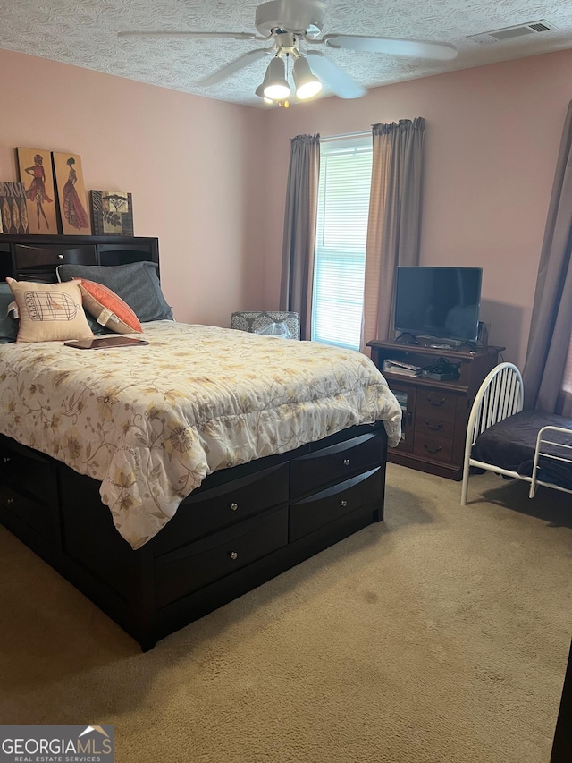 740 Pebble Blvd, Covington, GA 30016 - bedroom featuring light colored carpet, a textured ceiling, and ceiling fan