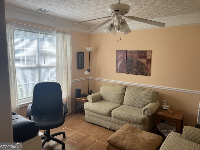 740 Pebble Blvd, Covington, GA 30016 - home office featuring a ceiling fan, wood finished floors, plenty of natural light, a textured ceiling, and crown molding