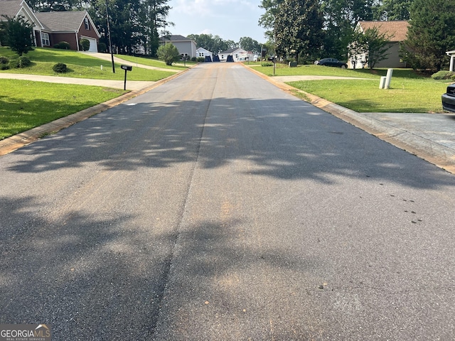 740 Pebble Blvd, Covington, GA 30016 - view of asphalt road with a residential view and curbs