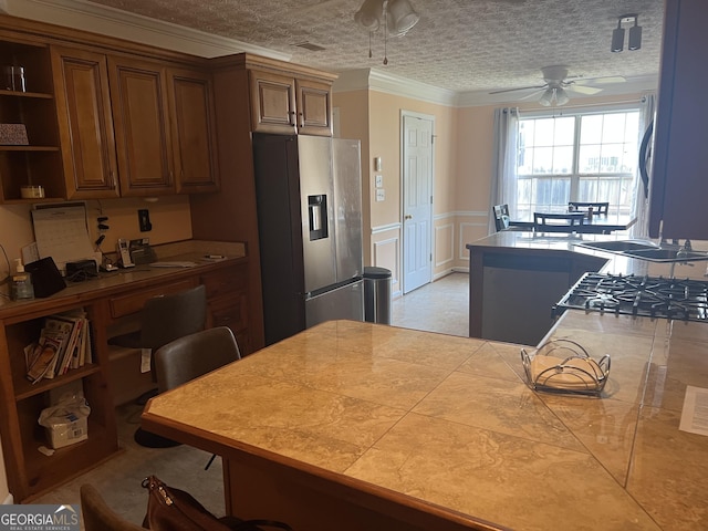 740 Pebble Blvd, Covington, GA 30016 - kitchen featuring stainless steel fridge, ceiling fan, open shelves, crown molding, and a wainscoted wall