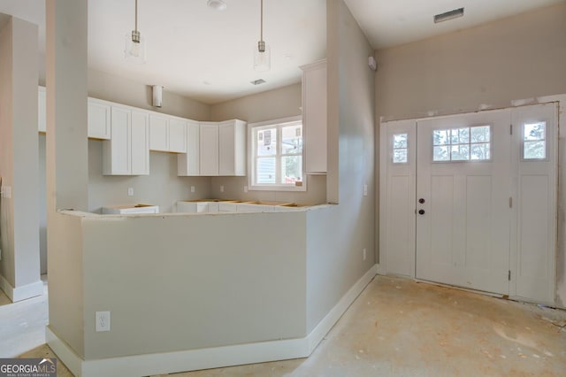 124 Flamingo Dr, Monticello, GA 31064 - kitchen with white cabinets and concrete floors