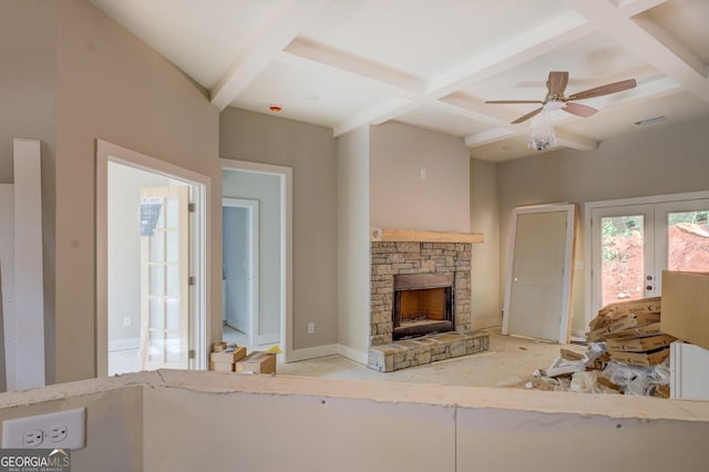 124 Flamingo Dr, Monticello, GA 31064 - unfurnished living room with coffered ceiling, french doors, a stone fireplace, beamed ceiling, and ceiling fan