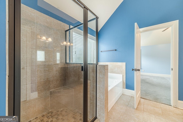 1022 Nestling Dr, Lawrenceville, GA 30045 - full bathroom with a garden tub, vaulted ceiling, a stall shower, tile patterned flooring, and baseboards