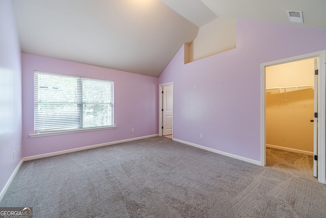 1022 Nestling Dr, Lawrenceville, GA 30045 - unfurnished bedroom featuring carpet flooring, lofted ceiling, a walk in closet, and baseboards