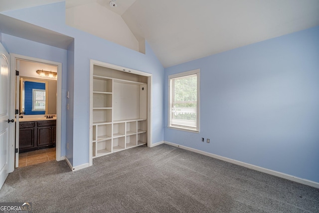 1022 Nestling Dr, Lawrenceville, GA 30045 - unfurnished bedroom featuring carpet flooring, lofted ceiling, baseboards, ensuite bathroom, and a sink
