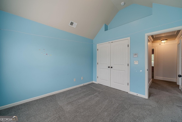 1022 Nestling Dr, Lawrenceville, GA 30045 - unfurnished bedroom featuring attic access, lofted ceiling, dark colored carpet, a closet, and baseboards