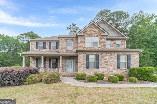 1022 Nestling Dr, Lawrenceville, GA 30045 - view of front of home with a porch, a front lawn, and brick siding