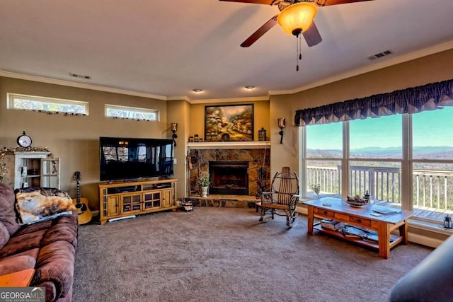 296 Tallulah Vw, Tallulah Falls, GA 30573 - living room featuring crown molding, carpet, a stone fireplace, and a ceiling fan