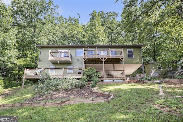 675 Wauka Ridge Rd, Clermont, GA 30527 - rear view of house with a balcony, a lawn, and a wooden deck