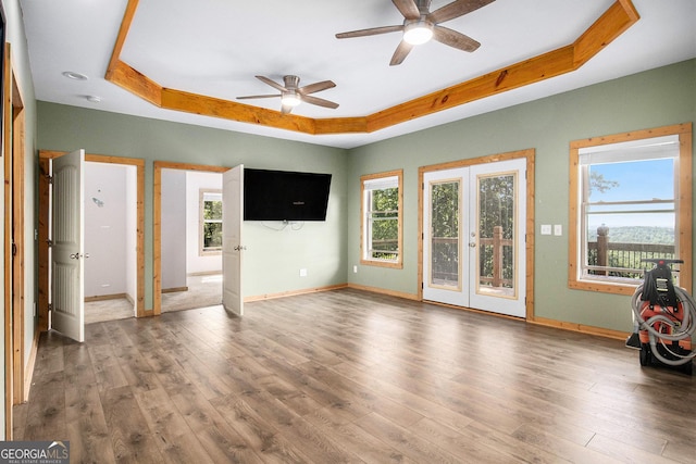675 Wauka Ridge Rd, Clermont, GA 30527 - unfurnished living room with a raised ceiling, a ceiling fan, healthy amount of natural light, and baseboards