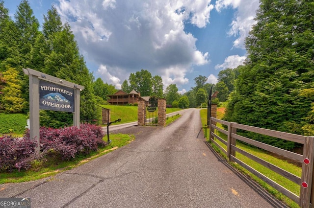 242 Noelle Ln, Dahlonega, GA 30533 - view of asphalt road featuring a gate