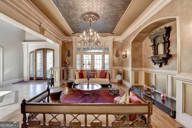 2279 Weeping Oak Dr, Braselton, GA 30517 - living room with french doors, a chandelier, arched walkways, and an ornate ceiling