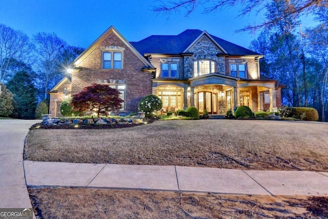 2279 Weeping Oak Dr, Braselton, GA 30517 - view of front of home featuring brick siding, a porch, and french doors