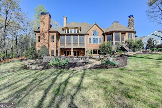2279 Weeping Oak Dr, Braselton, GA 30517 - rear view of house with a sunroom, a chimney, and a yard