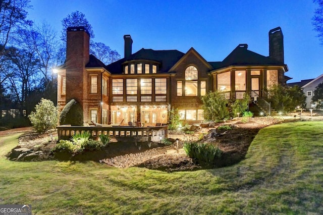 2279 Weeping Oak Dr, Braselton, GA 30517 - rear view of house with a chimney, a yard, and a deck