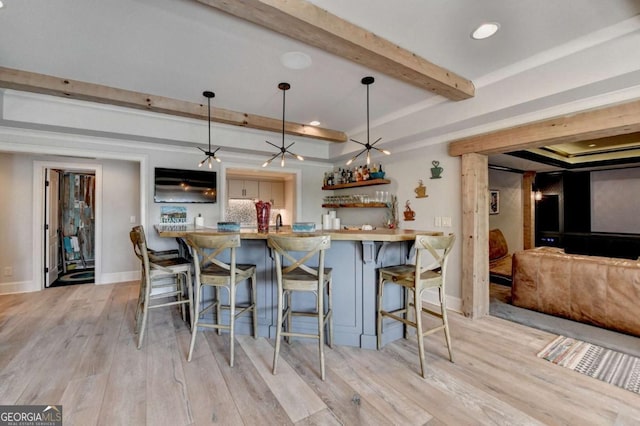 2279 Weeping Oak Dr, Braselton, GA 30517 - kitchen featuring beamed ceiling, a breakfast bar area, light wood finished floors, open shelves, and baseboards