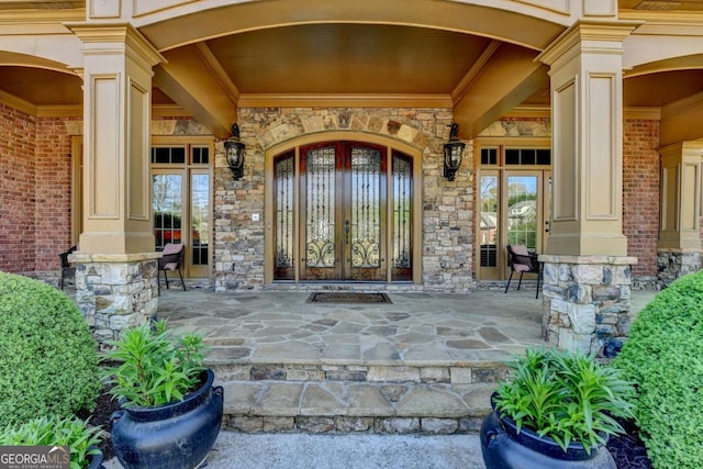 2279 Weeping Oak Dr, Braselton, GA 30517 - doorway to property with stone siding, a porch, and french doors