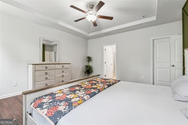 520 Edgemore Rd, Canton, GA 30114 - bedroom featuring a tray ceiling, wood finished floors, a ceiling fan, and baseboards