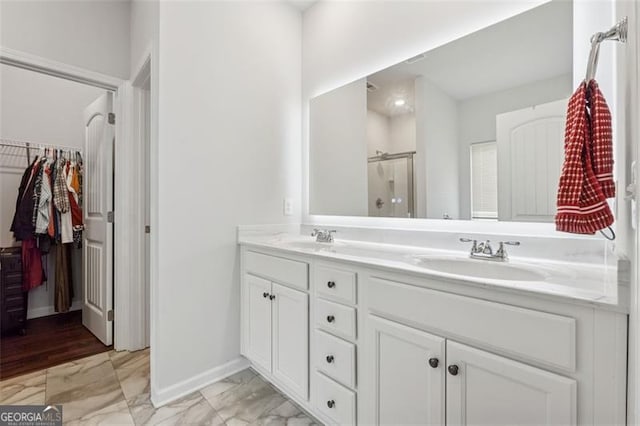 520 Edgemore Rd, Canton, GA 30114 - full bath featuring marble finish flooring, double vanity, an enclosed shower, baseboards, and a walk in closet