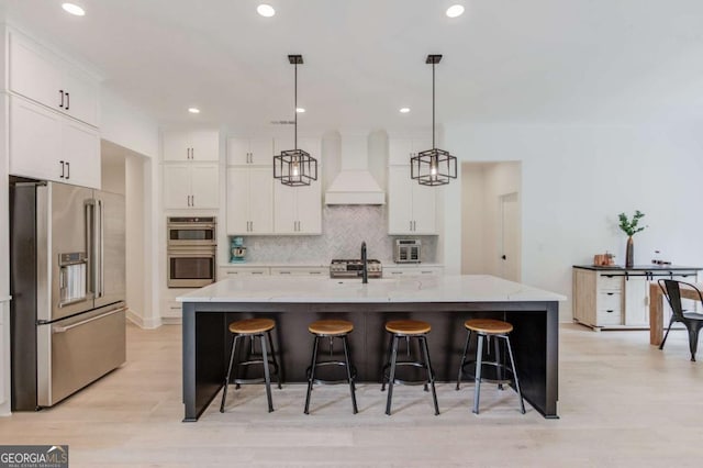5306 Weeping Creek Trl, Flowery Branch, GA 30542 - kitchen featuring stainless steel appliances, custom exhaust hood, white cabinets, a sink, and decorative backsplash