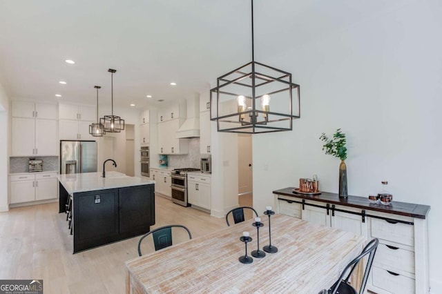 5306 Weeping Creek Trl, Flowery Branch, GA 30542 - dining space with a chandelier, light wood finished floors, and recessed lighting