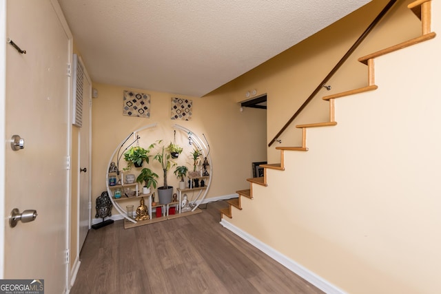 141 Stoneridge Dr, Warner Robins, GA 31088 - stairs with wood finished floors, baseboards, and a textured ceiling