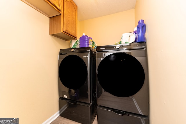 141 Stoneridge Dr, Warner Robins, GA 31088 - laundry area with cabinet space, washing machine and clothes dryer, and baseboards