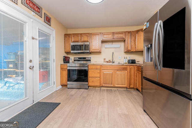 141 Stoneridge Dr, Warner Robins, GA 31088 - kitchen featuring stainless steel appliances, a sink, light wood finished floors, light countertops, and french doors