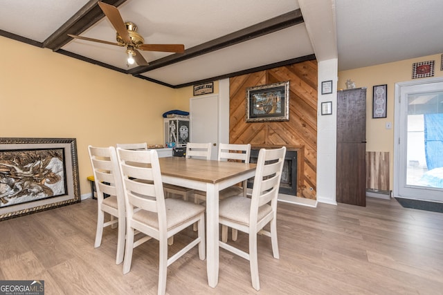 141 Stoneridge Dr, Warner Robins, GA 31088 - dining area with beamed ceiling, light wood-style flooring, a ceiling fan, baseboards, and wood walls